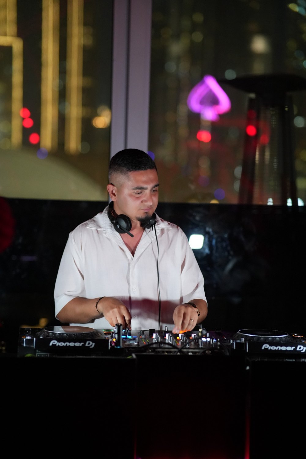 DJ KAYA performing at a night venue with headphones