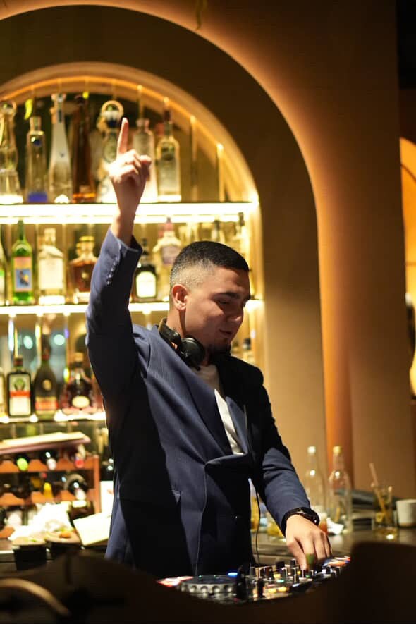 DJ KAYA performing at an elegant lounge venue
